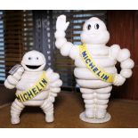 CAST IRON MICHELIN MEN. Two cast iron Michelin men, one standing and one money box. H - 20 & 15 cm.