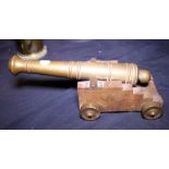 BRASS CANNON Brass cannon on wood truck with brass wheels. L - 30cm.