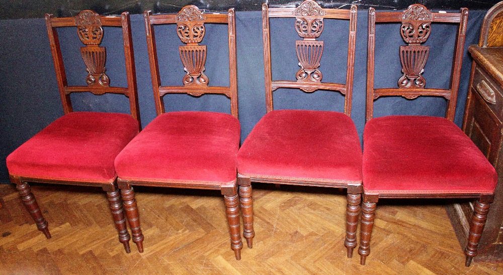 DINING CHAIRS. Four carved upholstered Edwardian dining chairs