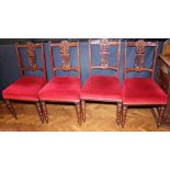 DINING CHAIRS. Four carved upholstered Edwardian dining chairs