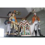 Four ceramic military figures and a military related teapot