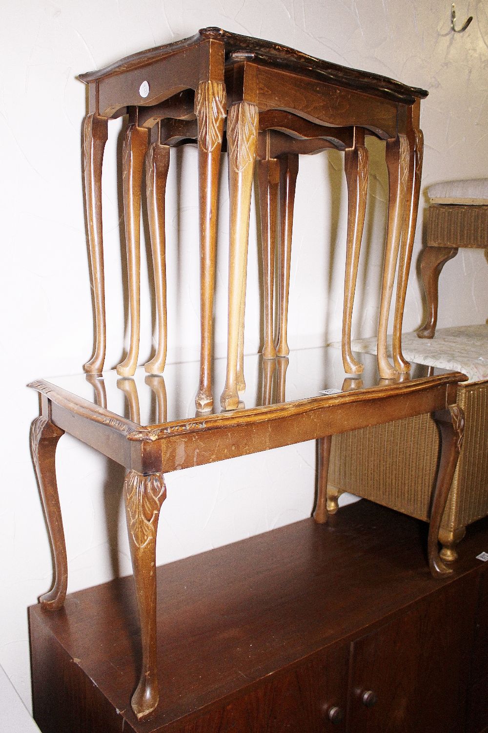 Nest of three mahogany tables and a single table