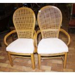 Pair of cane back carver chairs with upholstered seats