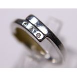 SILVER DIAMOND RING. Sterling silver ring set with three diamonds, size K/L