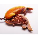 HAND CARVED CARP WITH ADULT THEMES. Hand carved wooden carp with adult themes inside