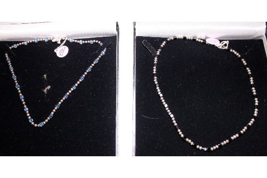 TWO BOXED NECKLACES. Two boxed necklaces