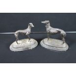 SPELTER GREYHOUNDS - A pair of reproduction spelter greyhounds, on a marble plinth,