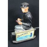 BULWARK ADVERTISING FIGURE - a Bulwark advertising figure - marked ITC 10229 - seen to be sitting,