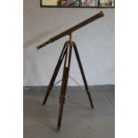 TELESCOPE - a brass telescope on a wood and brass tripod.