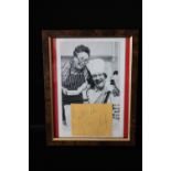TOMMY COOPER - a framed photograph of Tommy Cooper with an autograph slip stating "Best Wishes,