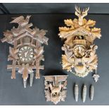 CUCKOO CLOCKS - two vintage wooden cuckoo clocks and a black forest carved shelf.