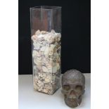 SHELL/SKULL - a tall glass vase filled with shell and a decorative resin skull.