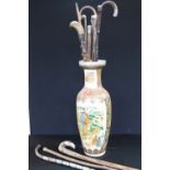 WALKING STICKS AND VASE - a collection of eleven walking sticks to include one measuring stick.