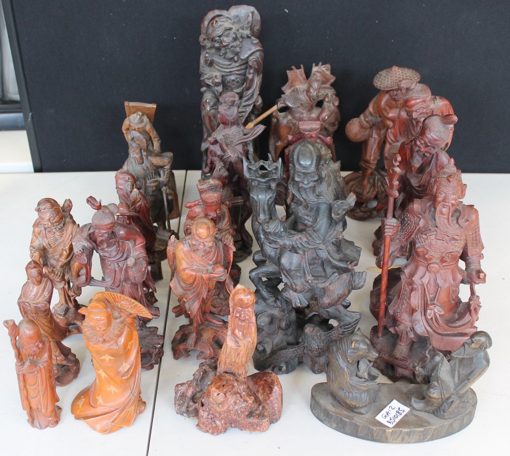 ORIENTAL WOODEN FIGURES - a collection of twenty-five 20th Century figures made from mahogany,