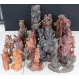 ORIENTAL WOODEN FIGURES - a collection of twenty-five 20th Century figures made from mahogany,