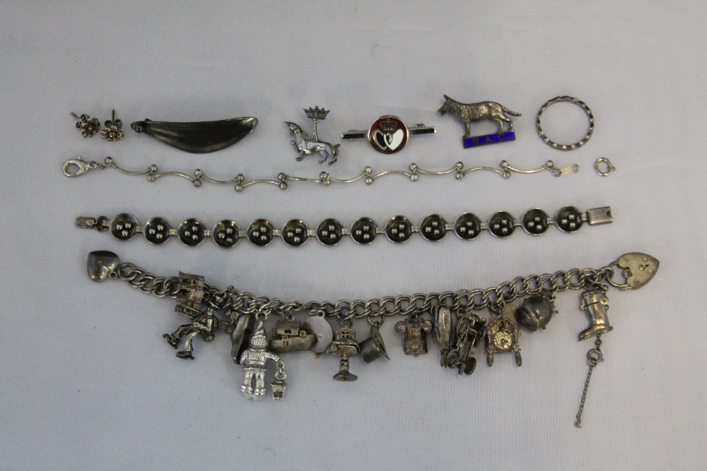 JEWELLERY - a silver charm bracelet containing 15 charms of which 10 are silver (total weight of