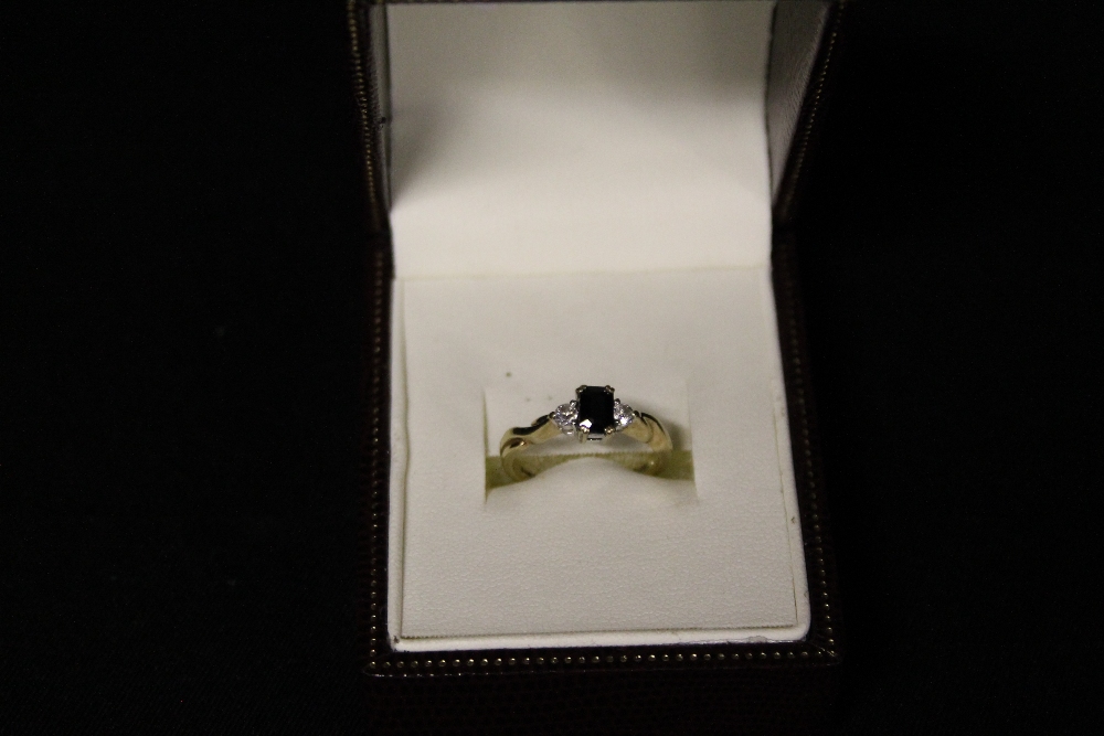 JEWELLERY - a 9ct emerald cut Sapphire with two Diamonds on the shoulder, weight of the ring is 2.