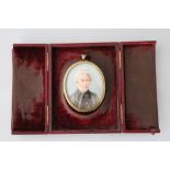PORTRAIT MINIATURE - a Victorian miniature on ivory mounted in a burgundy leather frame stamped by