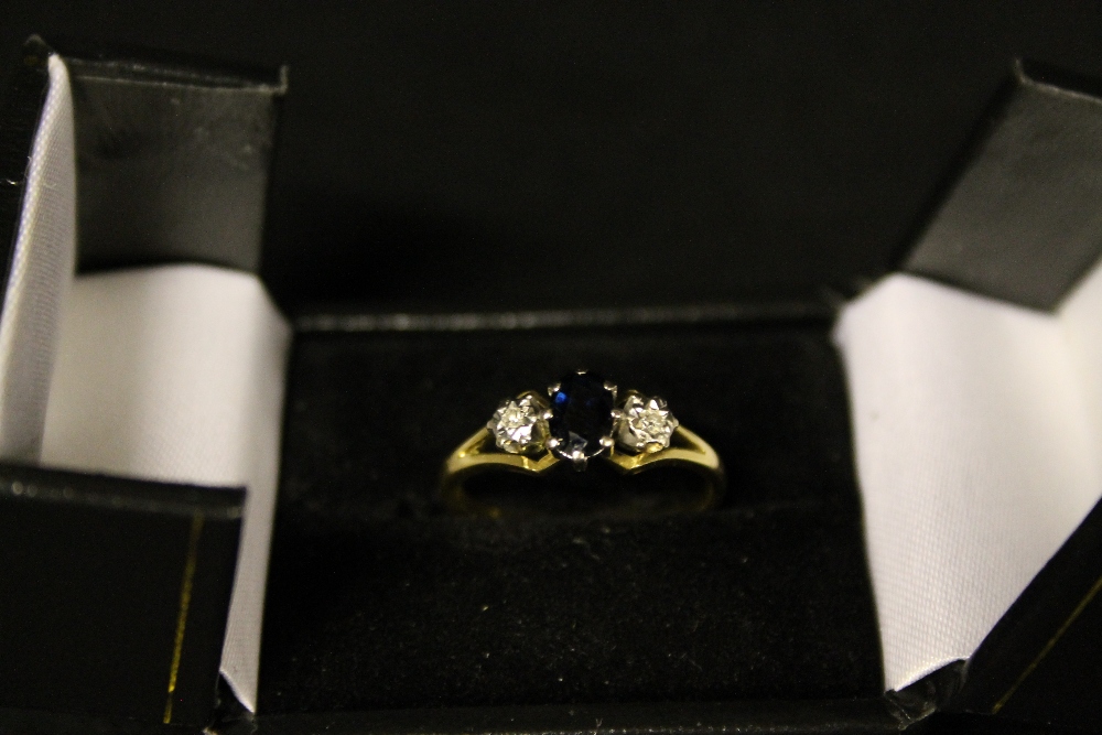 JEWELLERY - a 18ct Sapphire set, flanked with two melee rub set diamonds, weight of the ring is 3.