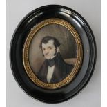 PORTRAIT MINIATURE -  a early C19th miniature of a gentleman on ivory, framed in a oval black frame,