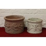 Two decorative terracotta planters.