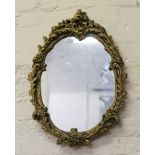 An ornate gilt framed wall mirror.