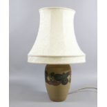 An ornate pottery based tablelamp and sh