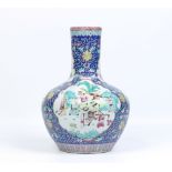 A twentieth century large Chinese bottle vase. Ground in dark blue, enamelled with stylized