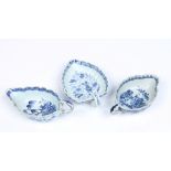 Three eighteenth century Chinese porcelain sauceboats. With fluted moulding and loop handles. All