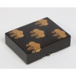 A Japanese Hiramaki lacquer papier mache box and cover. Decorated in gilt with stylized leaves,