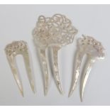 Three early twentieth century carved mother of pearl hair ornaments, each with openwork pediments.