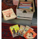 A box of books and childrens annuals.