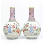 A large pair of Chinese twentieth century bottle vases. Both decorated in coloured enamels with a