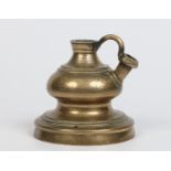 A seventeenth century Eastern cast bronze vessel, possibly an oil lamp.  With plain loop handle