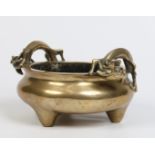 A nineteenth century Chinese bronze censor. With twin dragon moulded handles and raised on three