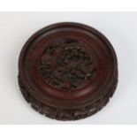 A nineteenth century Chinese hardwood circular ornament stand. Carved and pierced with a dragon to