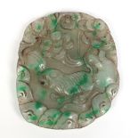 A Chinese carved hardstone pendant of oversized proportions. Depicting a lion in a wooded