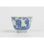 A nineteenth century Chinese teabowl. Painted in underglaze blue with a three figures conversing