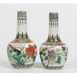 A pair of Chinese famille verte bottle vases. Painted with birds and peonies under trellis