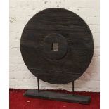 A large decorative wooden wheel on stand