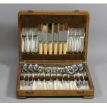 An oak cased canteen of cutlery.