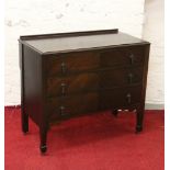 An Edwardian mahogany three high chest of drawers raised on tapering spade feet.