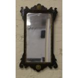 A mahogany framed wall mirror with gilt decoration.