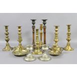 A collection of mainly brass candlesticks to include side plate,