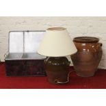 A painted tin storage trunk along with a large stone pot and another stoneware jar converted to