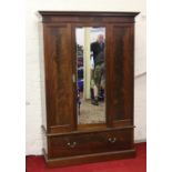 An Edwardian mahogany mirror front wardrobe over base drawer no back panel.
