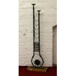 A decorative wrought iron two branch floor standing candle holder.