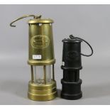 A brass Limelight Company Hockley miners lamp along with a smaller carved coal miners lamp.