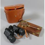 A cased pair of Trentor 10x50 binoculars along with a boxed magnifying glass.