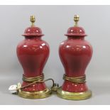 A large pair of oriental baluster pottery tablelamps in a sang de boeuf glaze.